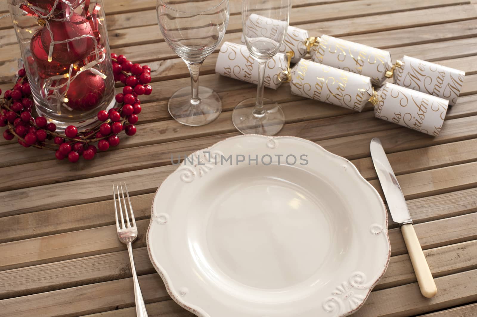 Overhead view of place setting with classic plate and christmas accents