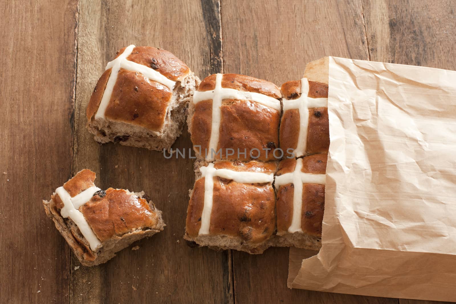 Fresh square hot cross buns sticking out of paper bag