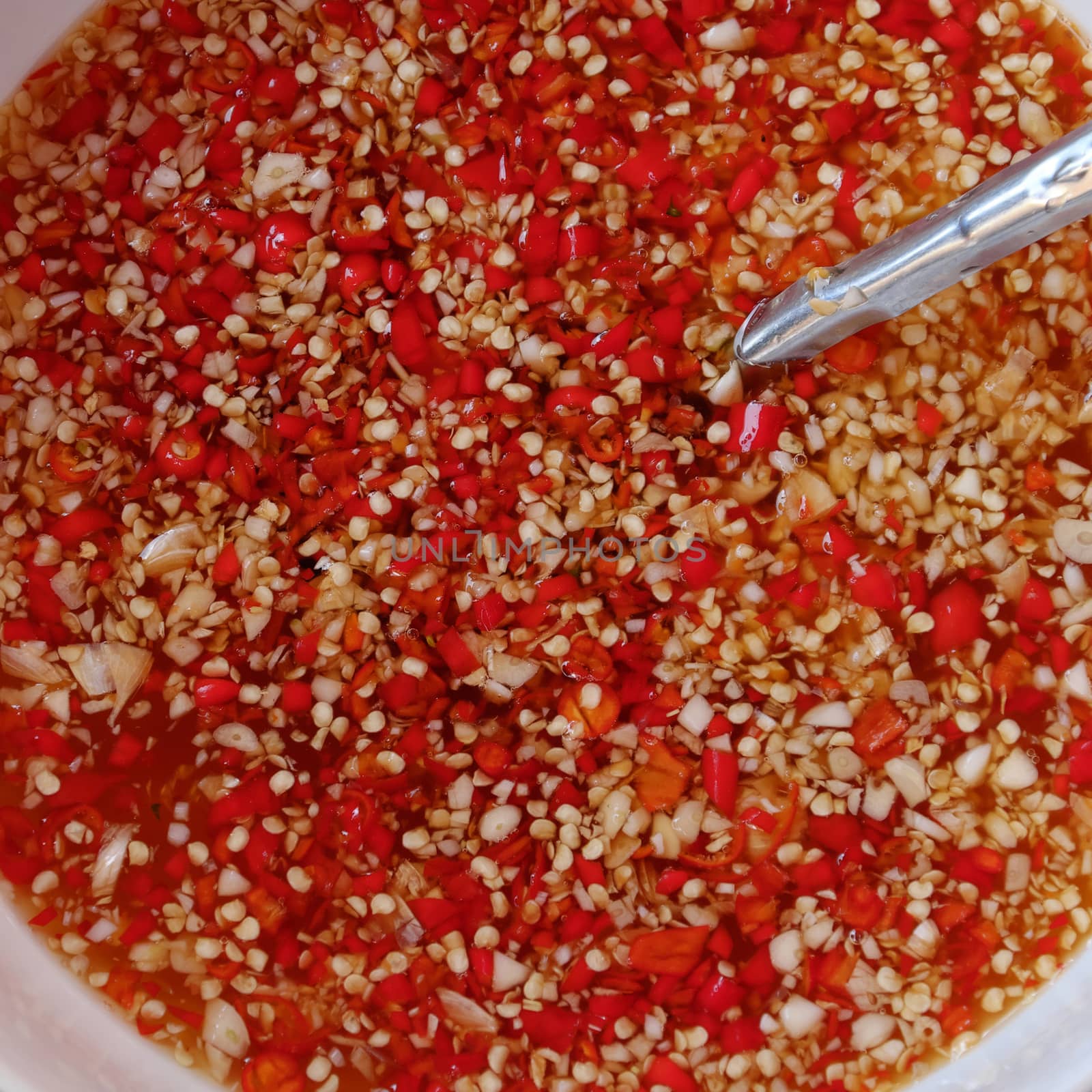 Vietnamese sauce for food, fish sauce with red hot chilli and choped garlic, amazing bowl of red
