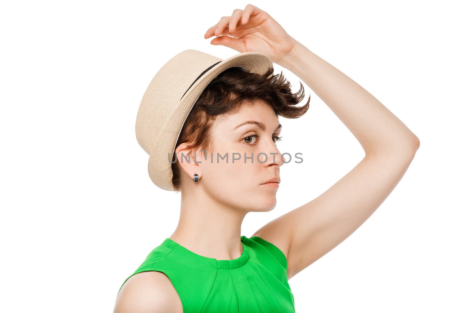 hand woman straightens his hat on his head on a white background portrait