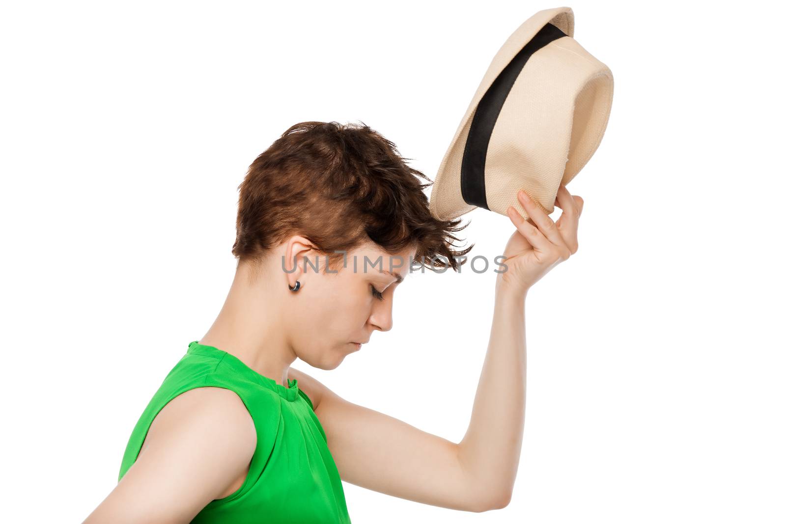 fitting of a straw hat on a white background