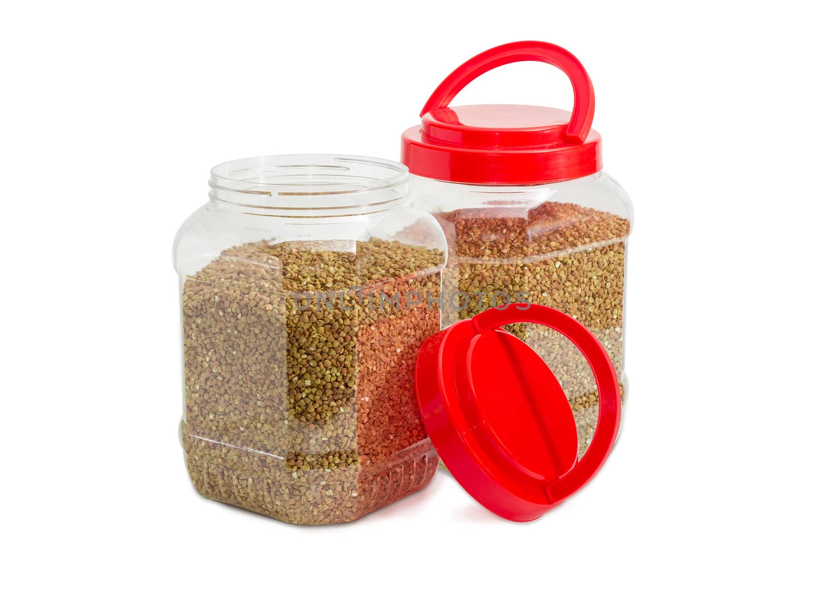 Buckwheat groats in two plastic containers with red covers by anmbph