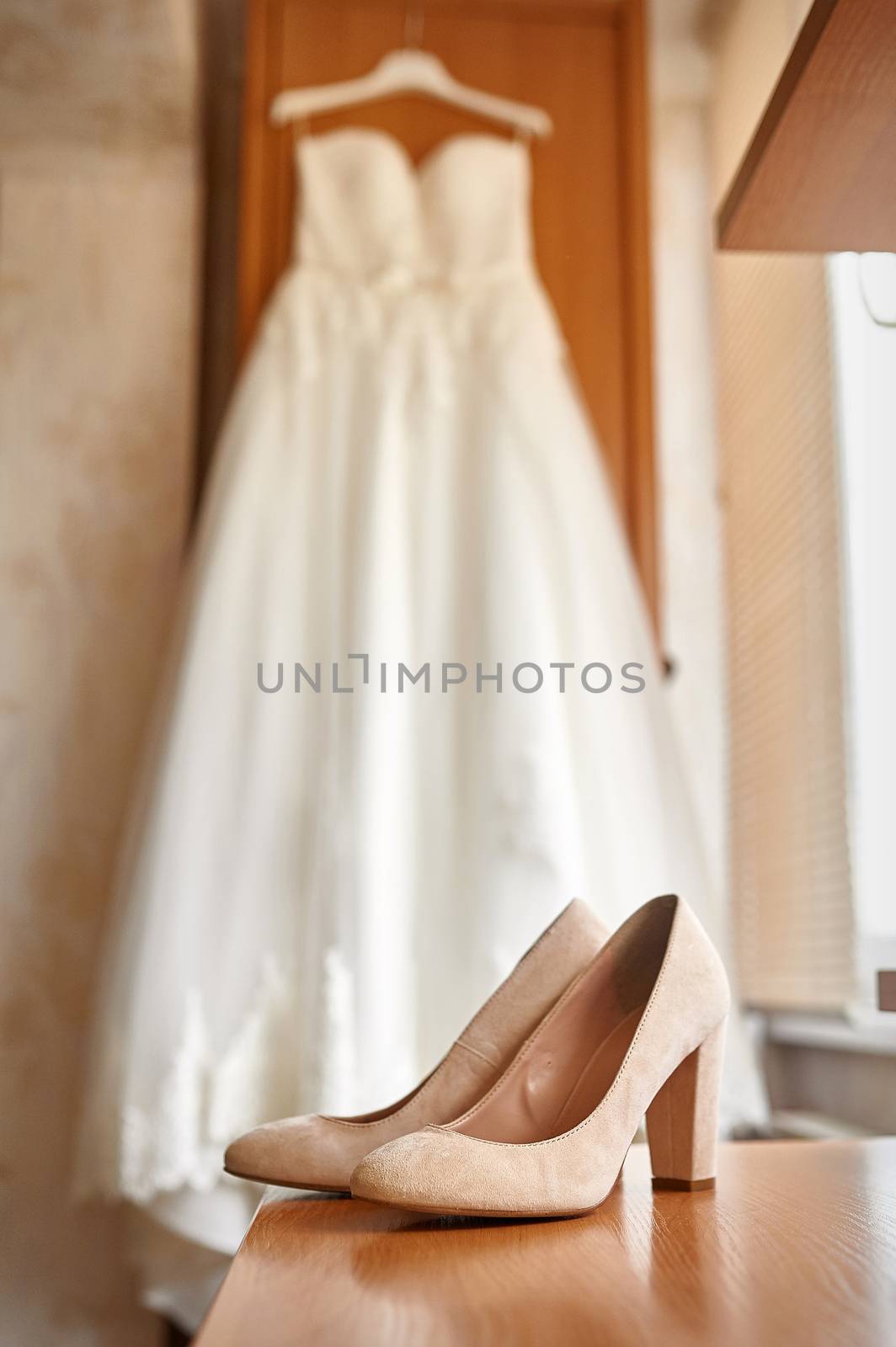 wedding shoes and bride in a bedroom by timonko