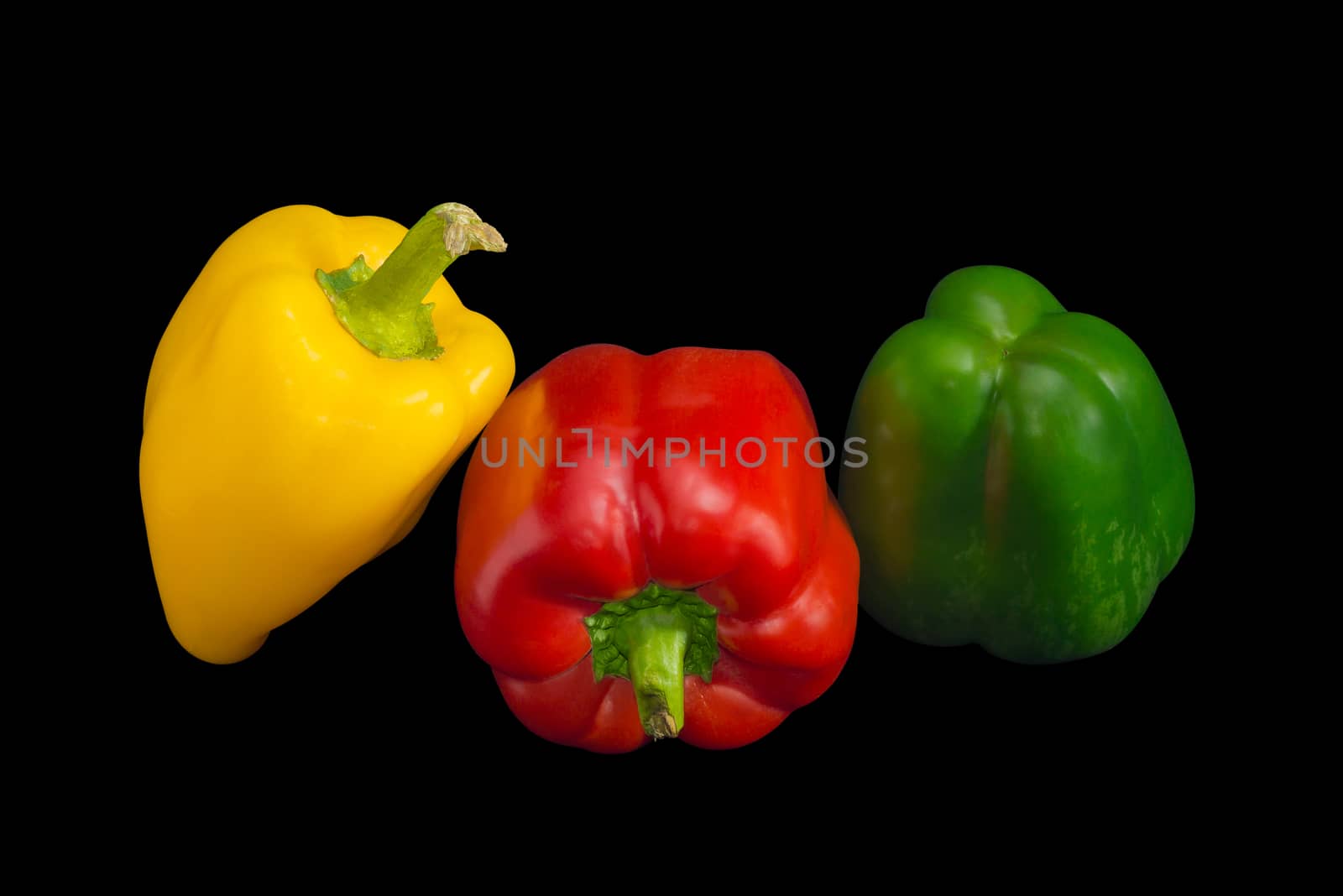 Fresh yellow, red and green bell peppers on a dark background
