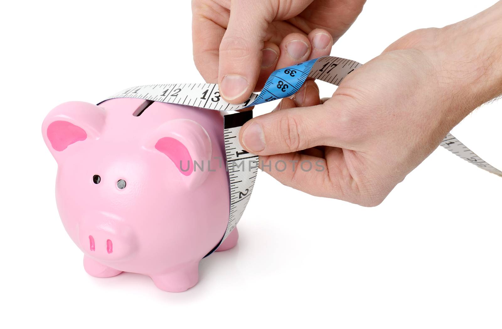 Concept of measuring your wealth, measuring tape around a piggy bank isolated on a white background