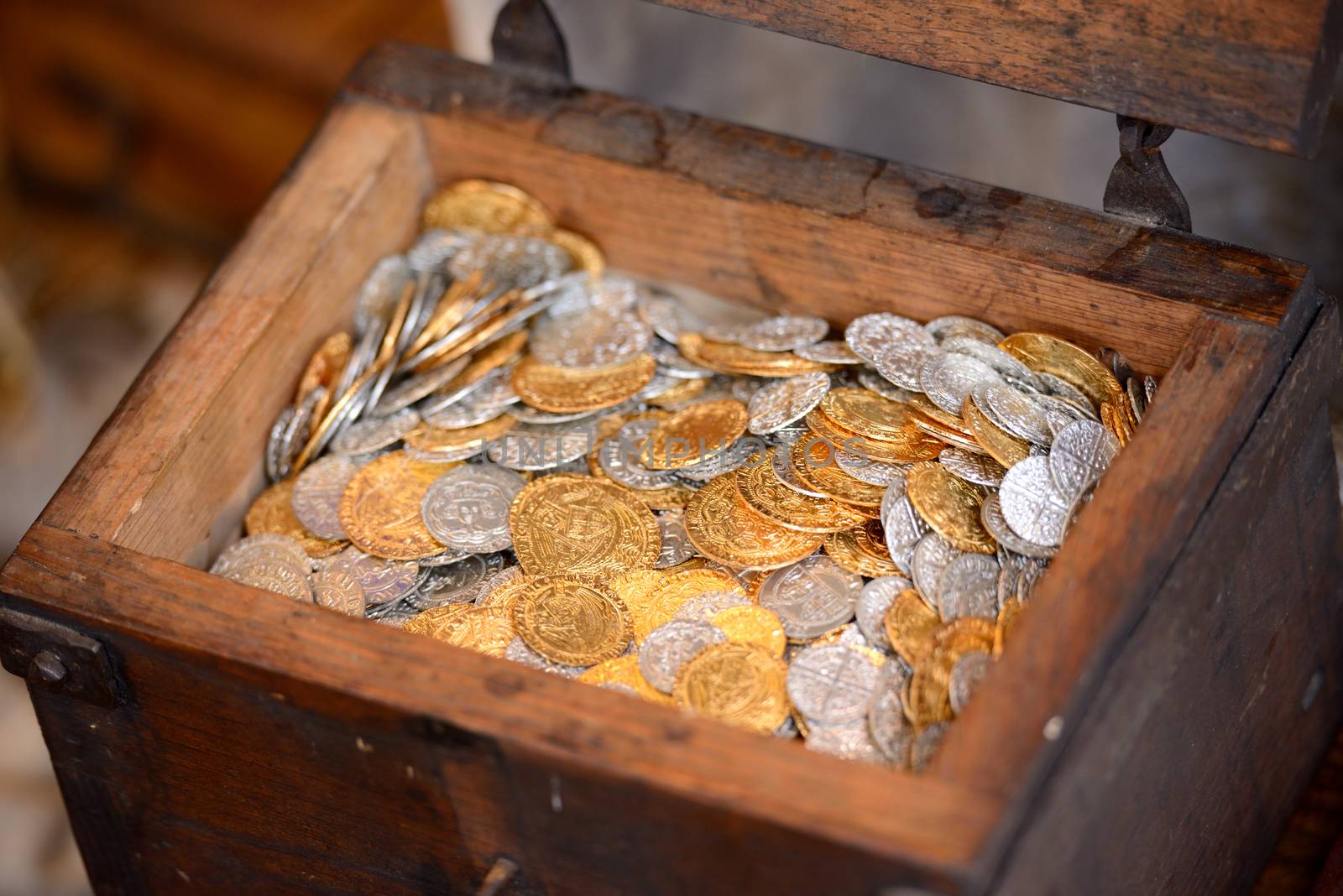 Old wooden treasure chest full of coins