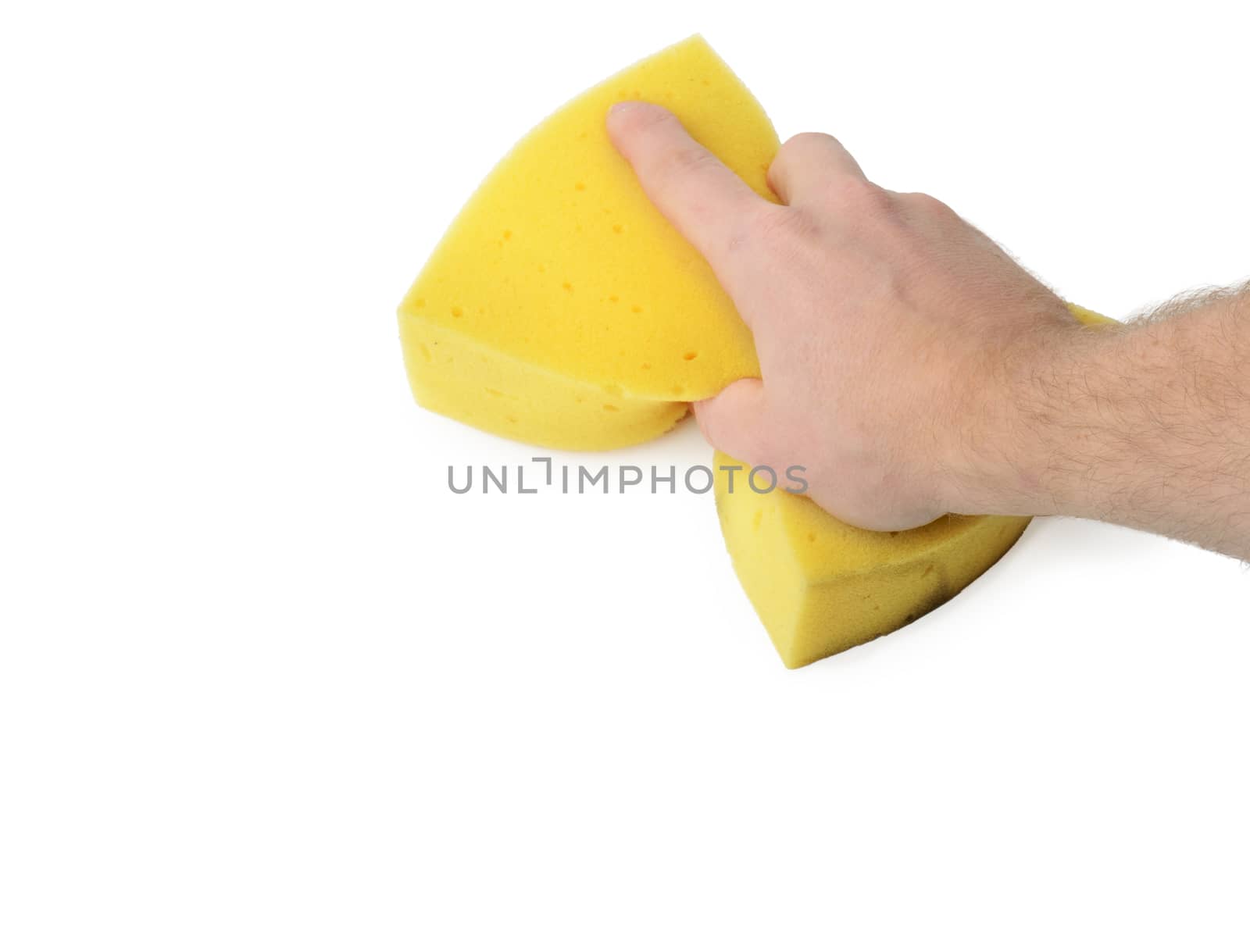 Hand holding a sponge wiping a white surface