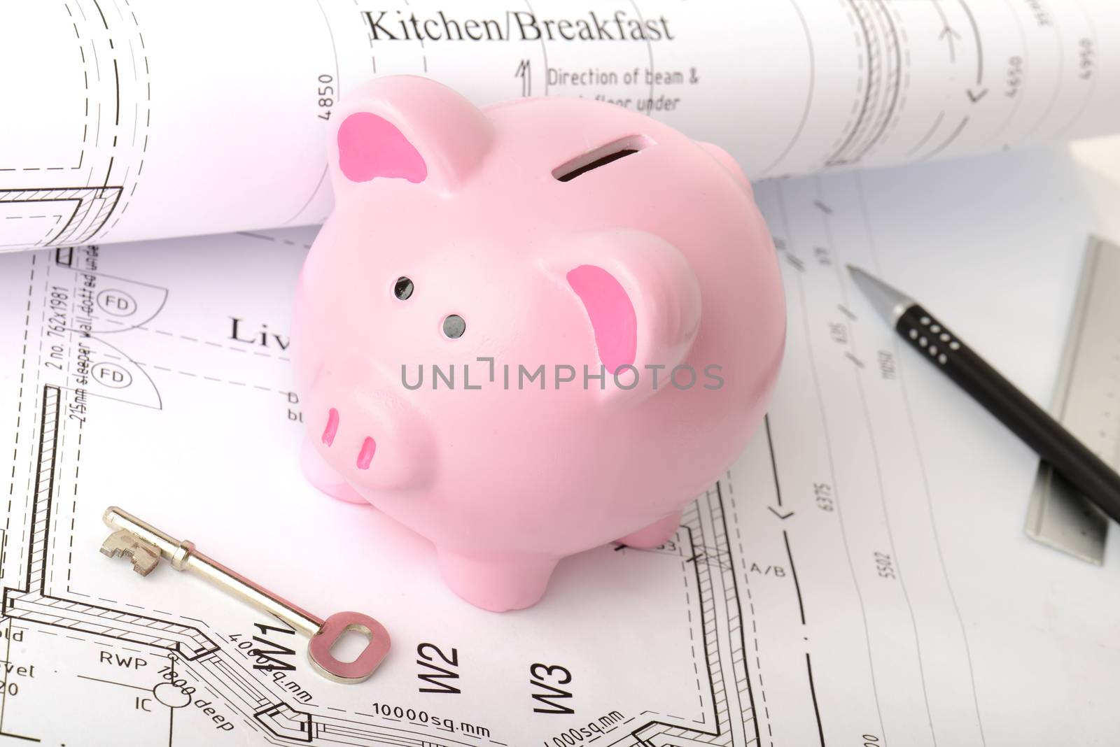 concept of saving for a new home, a piggy bank on new house plans
