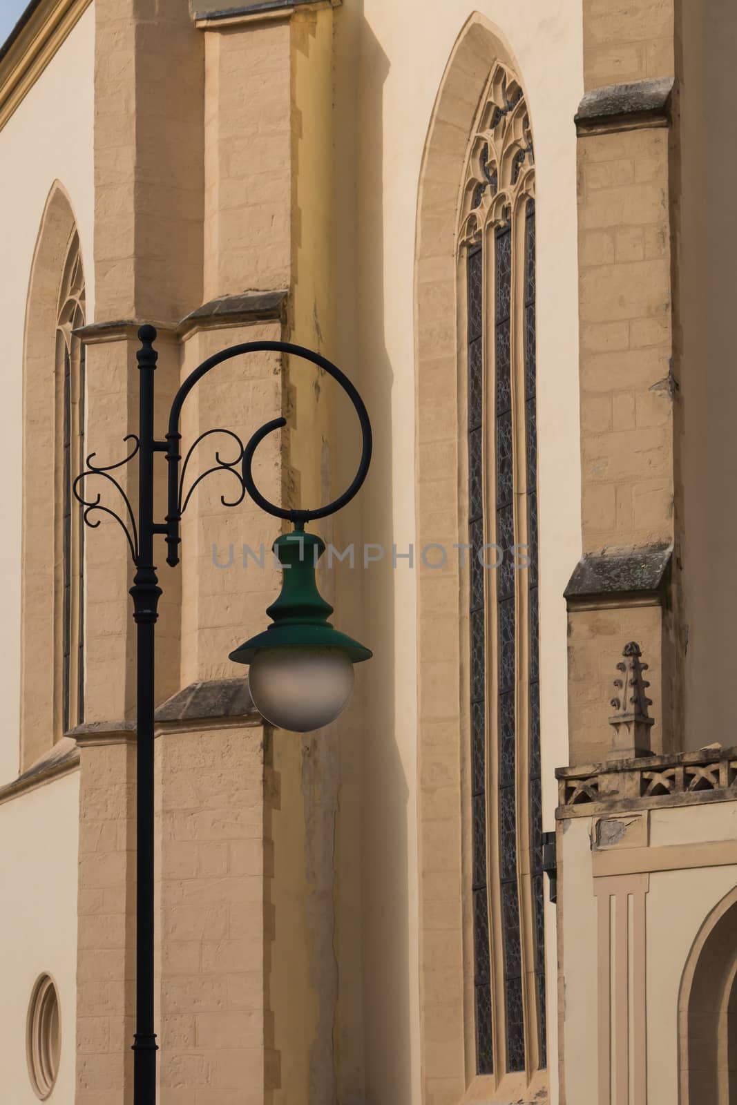 Lines of the facade of a gothic St. Jacob church in city Boskovice, Czech republic. Stylish street lamp in the foreground.