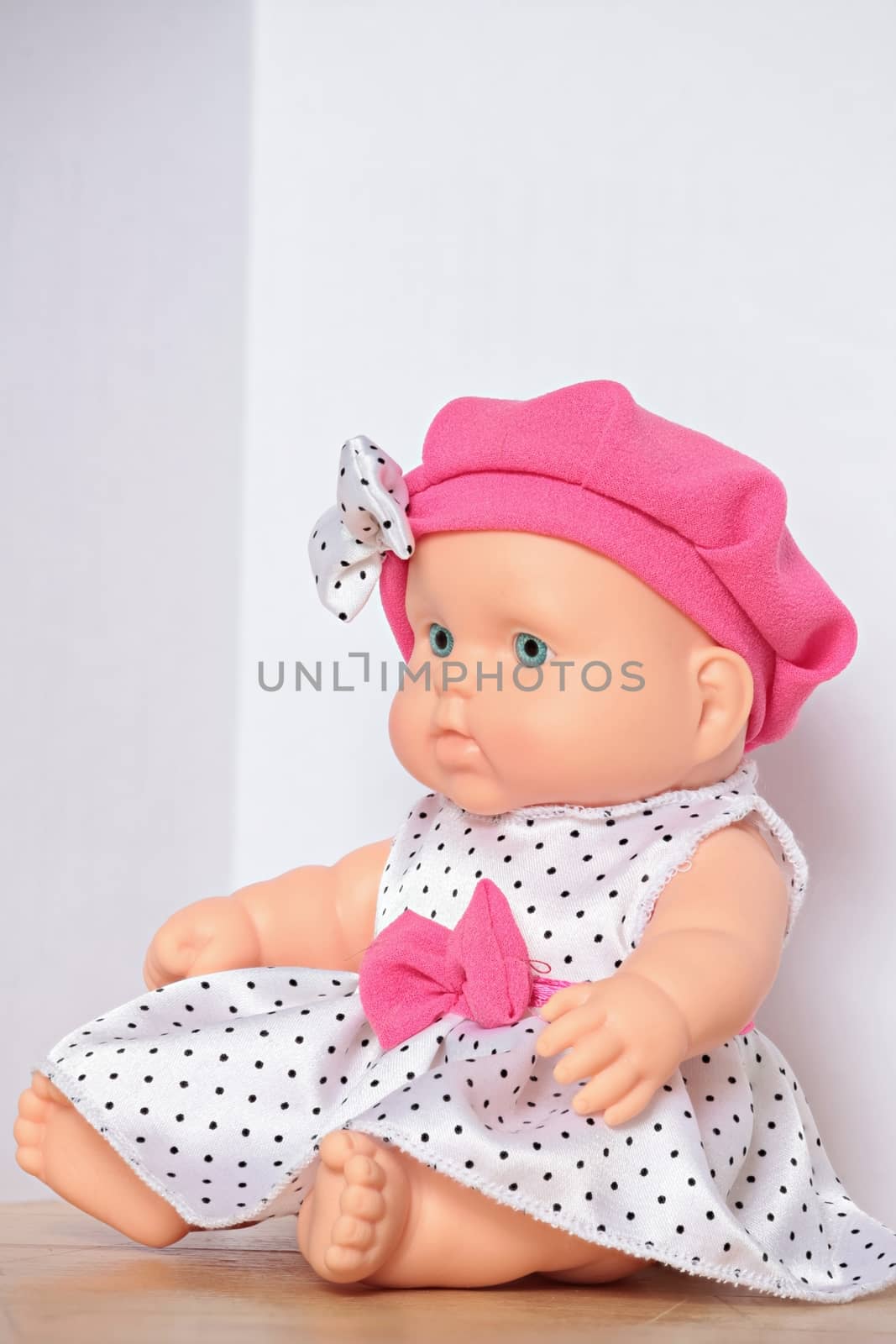 doll with pink bow close to
