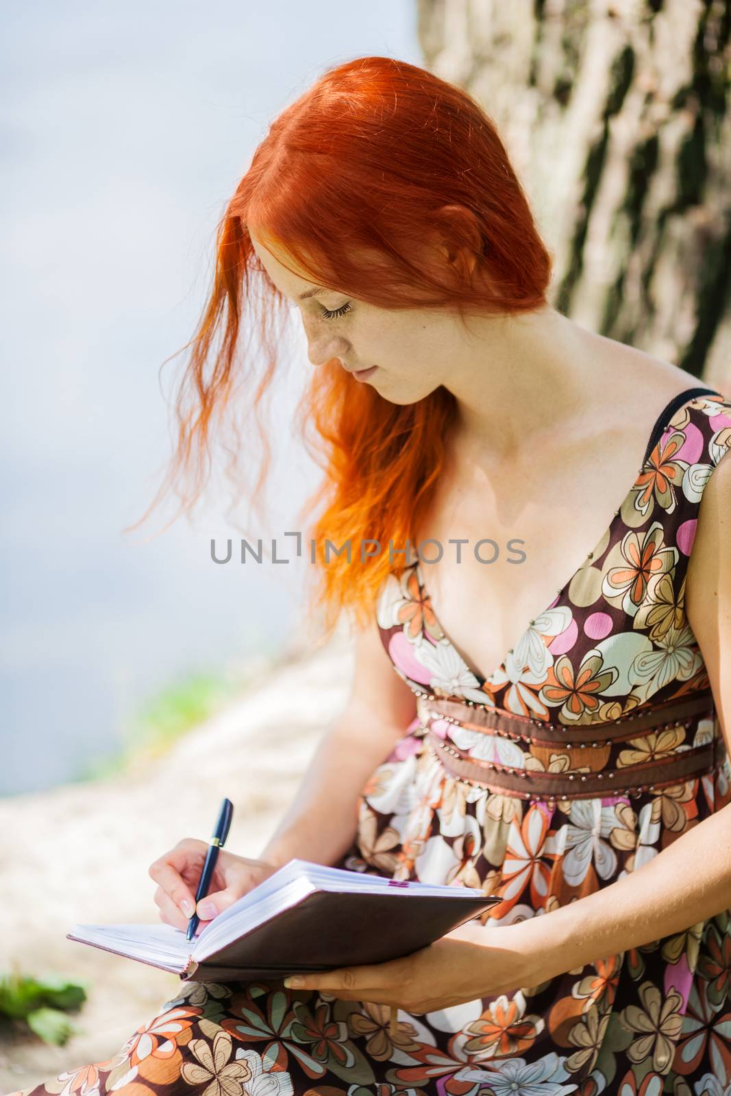 Student writing outdoors by olga_sweet