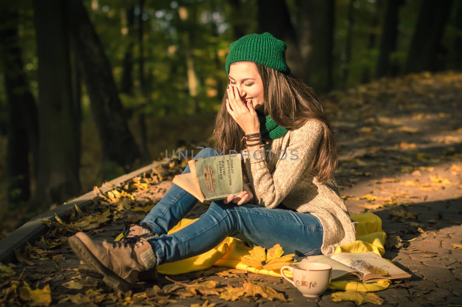 girl reading a book sitting on the track in a Park