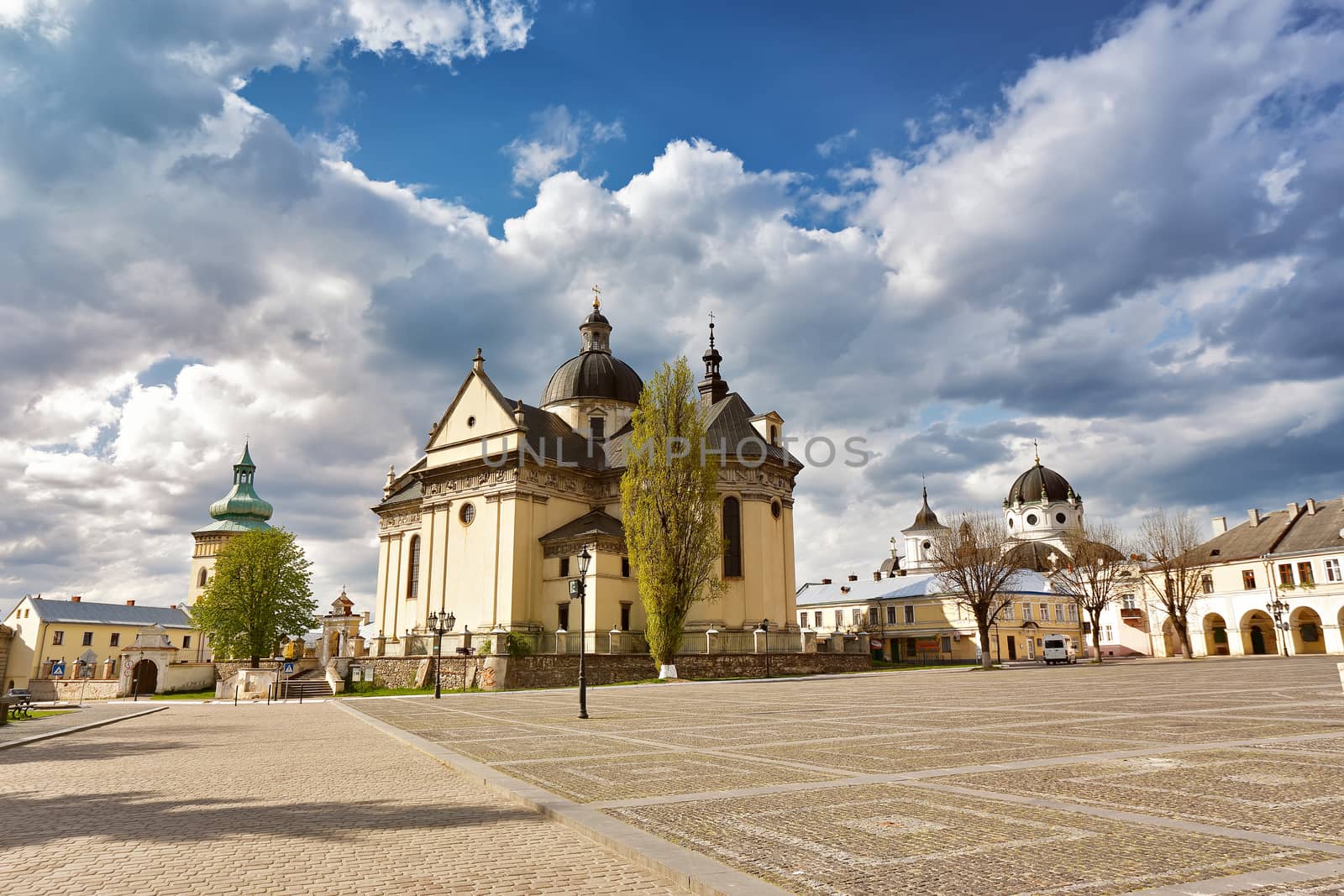 Old cathedral and church. Square in old town. Sunny cloudy cityscape