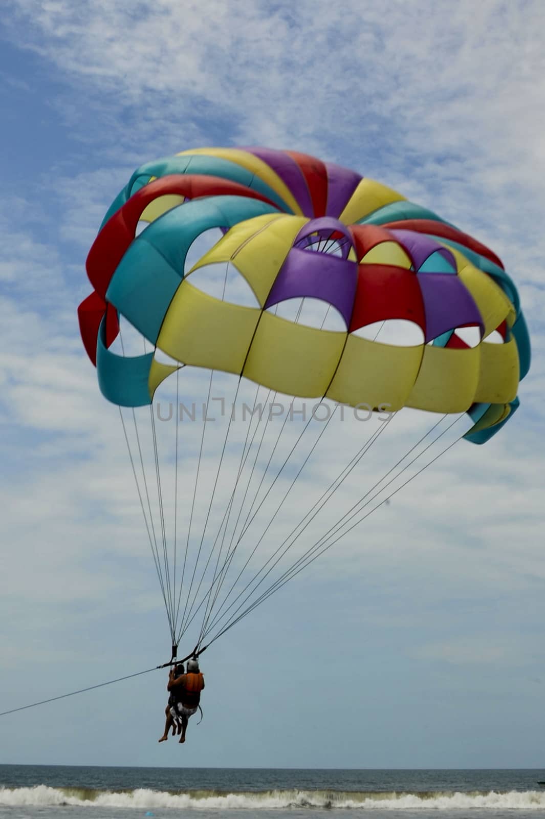 Paragliding pulled by a motorboat on the beach
of  equator