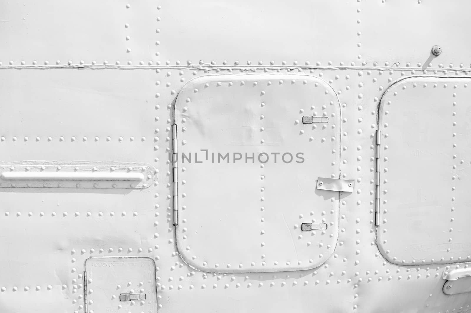 Aircraft metal plating texture with rivets background.