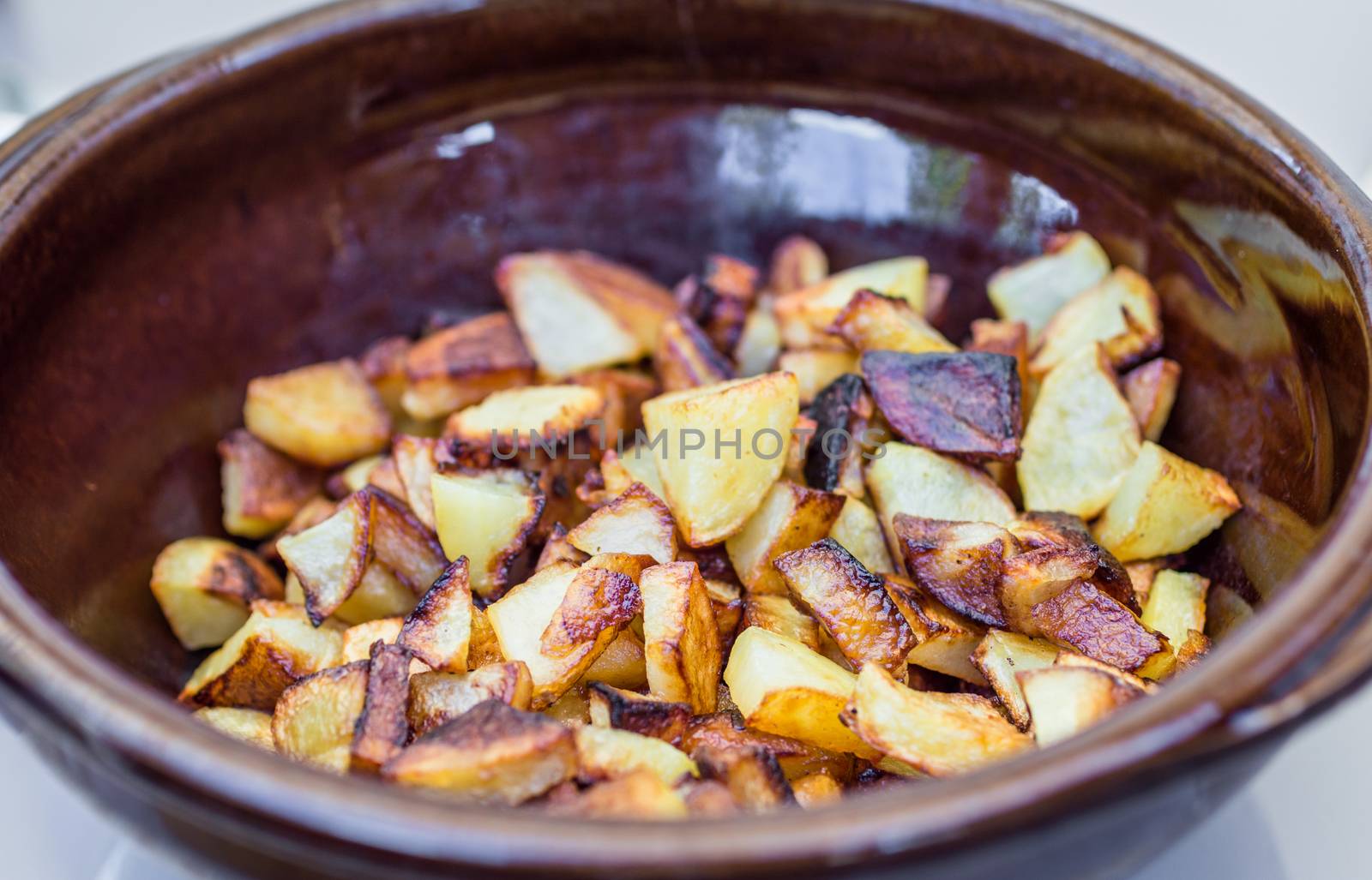 delicious roasted potato in bowl on table