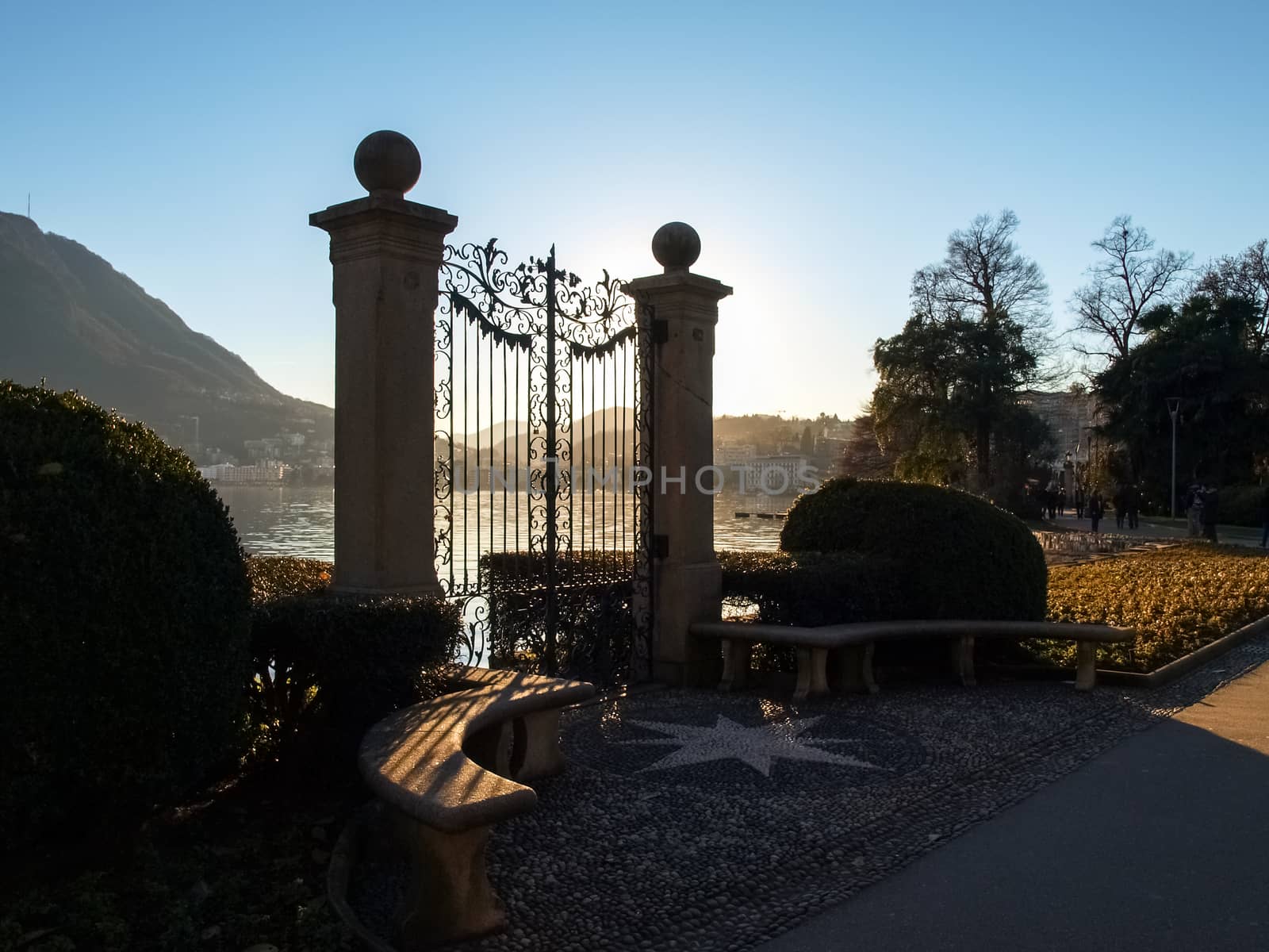 Lugano, Switzerland. Old gate for access to the lake of the park Ciani oldest botanical garden. The park is famous and visited by many tourists every year.