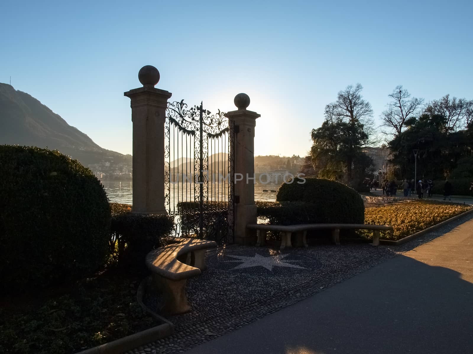 Lugano, Switzerland. Old gate for access to the lake of the park Ciani oldest botanical garden. The park is famous and visited by many tourists every year.