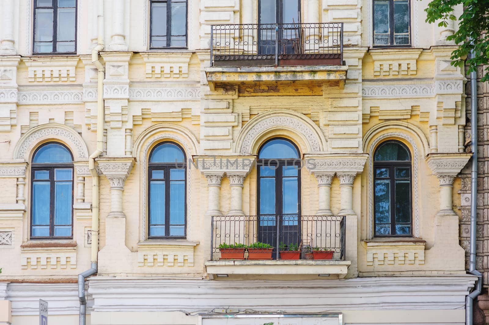 ancient architectural high rise building with windows and pillars by timonko