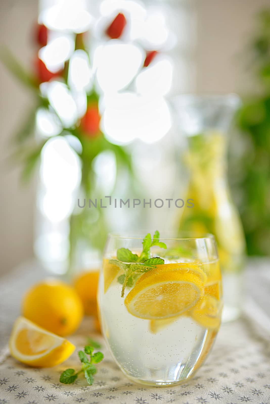 Fresh limes and lemonade on table