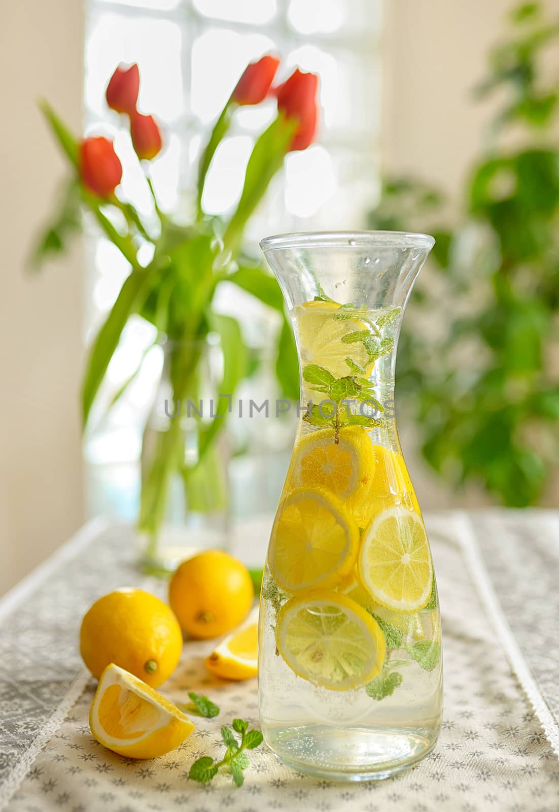 Fresh limes and lemonade on table