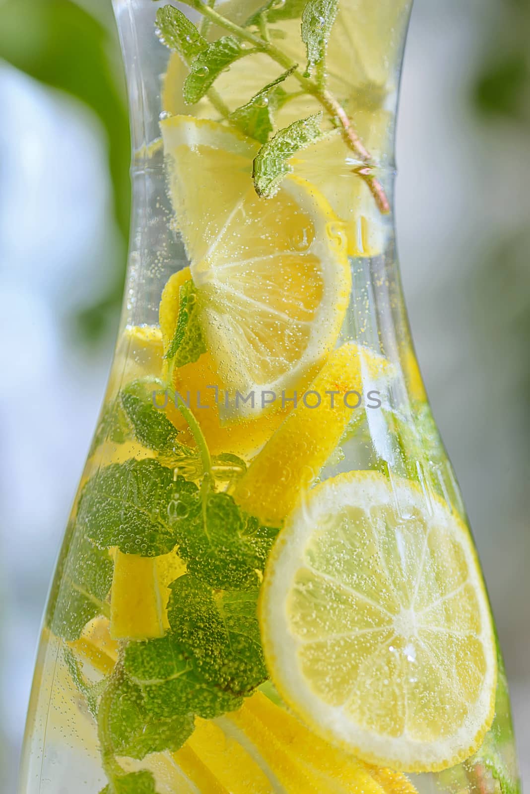 Fresh limes and lemonade in bottle