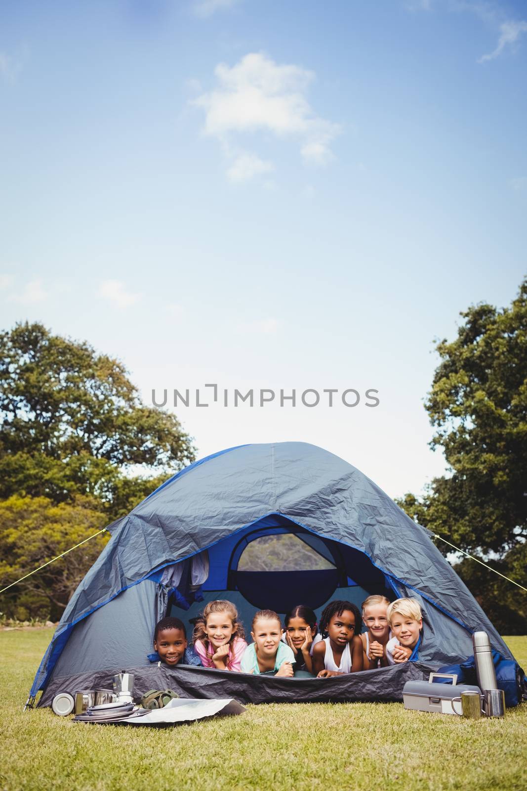  Smiling kids lying in the tent together by Wavebreakmedia