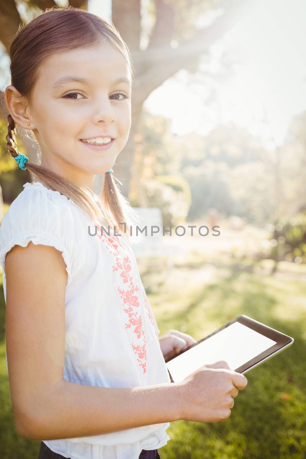 Kid using technology during a sunny day by Wavebreakmedia