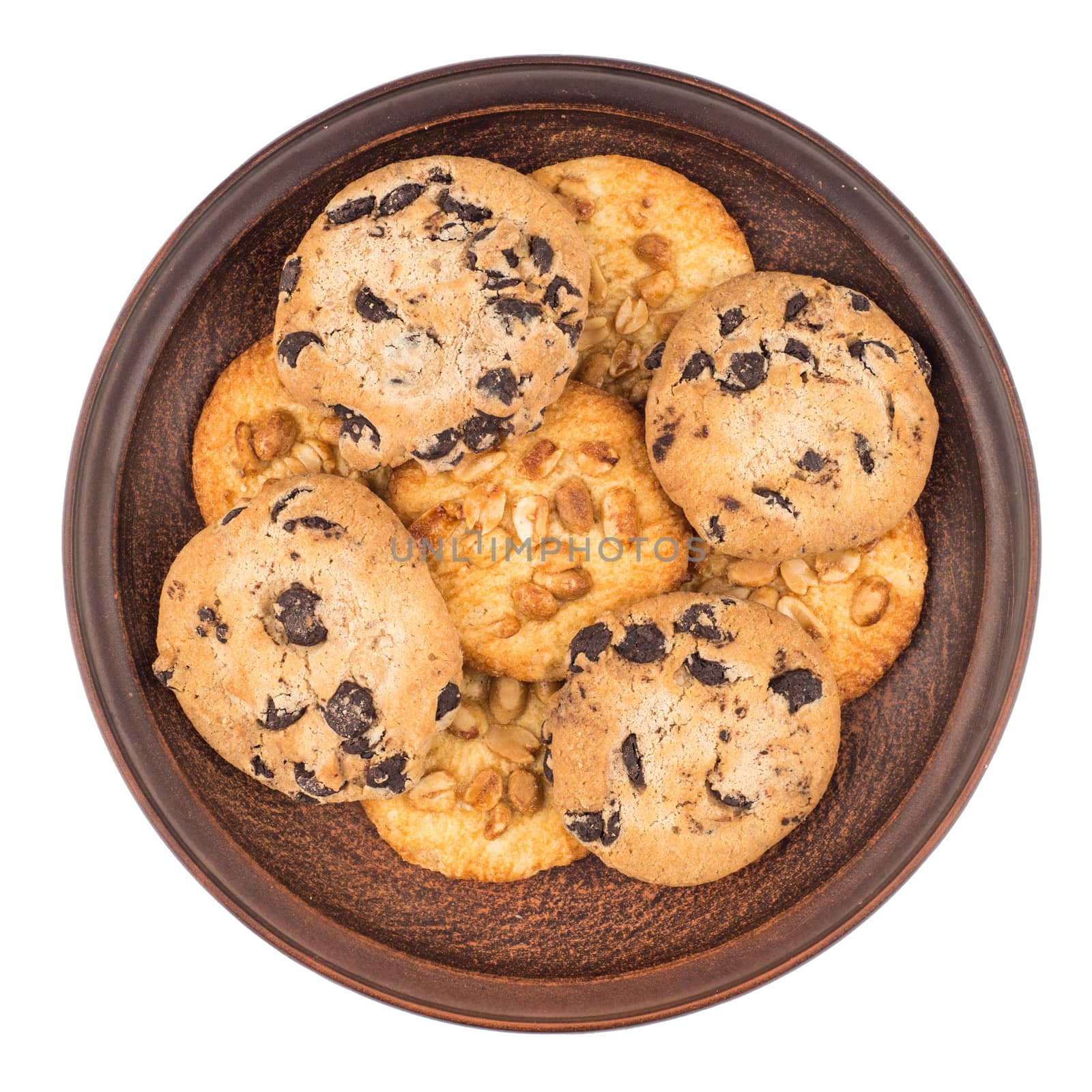 Cookies with peanuts and chocolate in a brown plate. Isolated on white background. Top view.