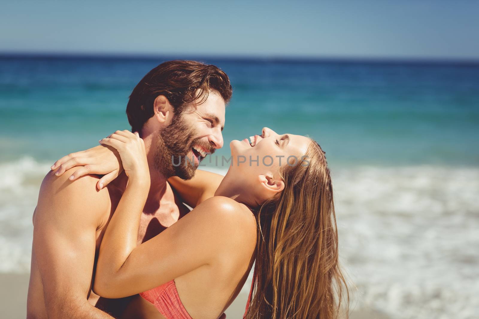 Romantic young couple having fun on beach