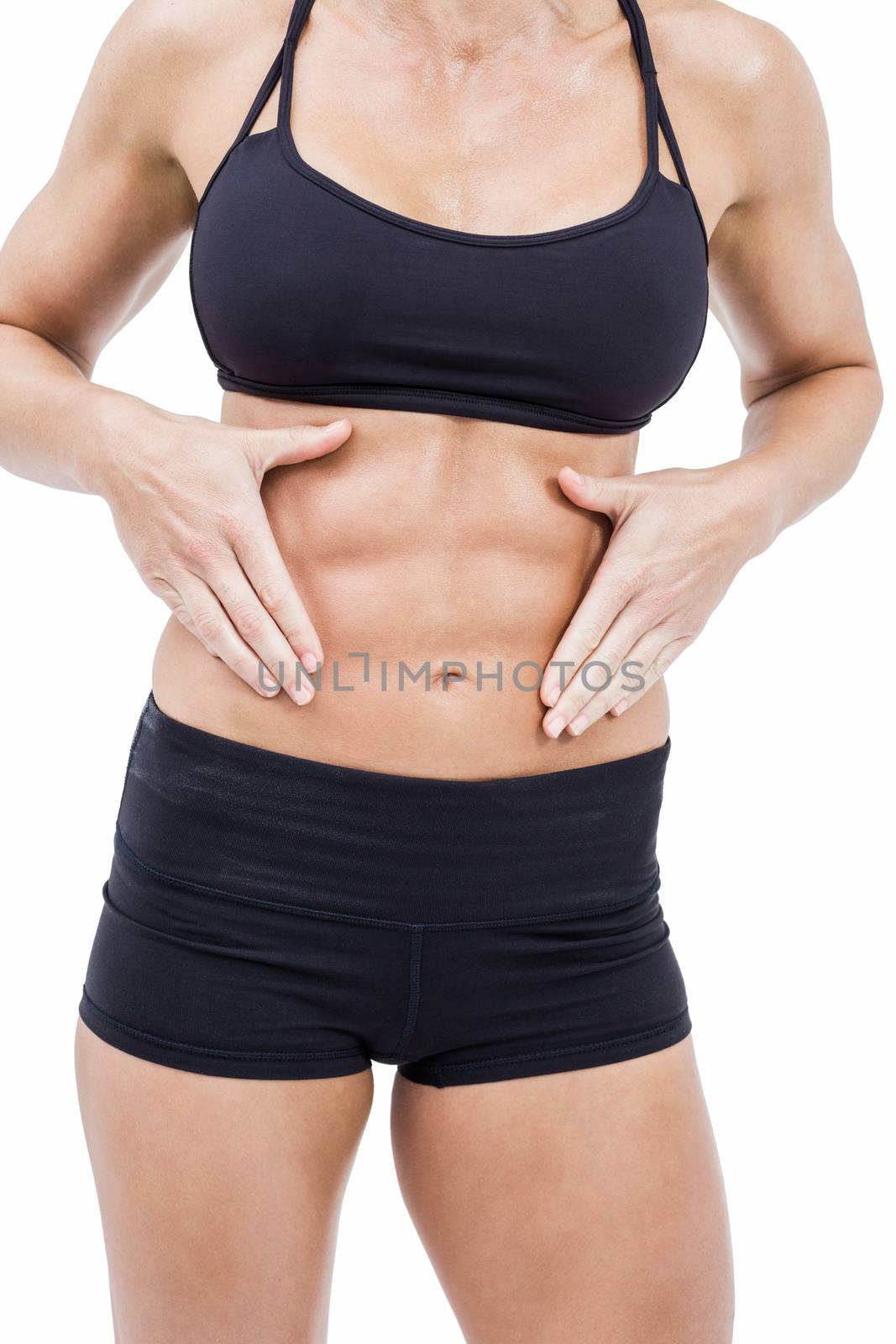 Female athlete touching her abs by Wavebreakmedia