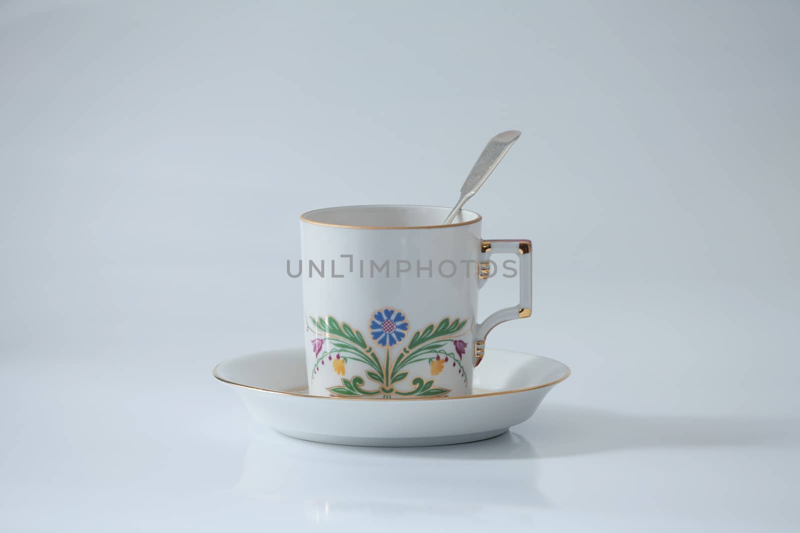 tea cup with a beautiful flower pattern and spoon