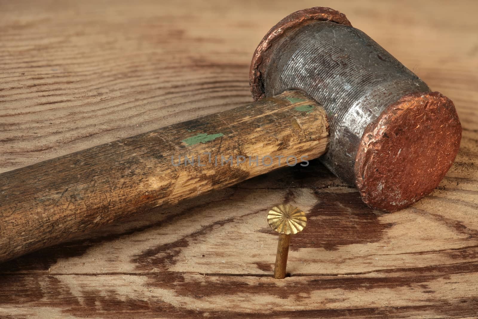 copper hammer and gold nail macro shot