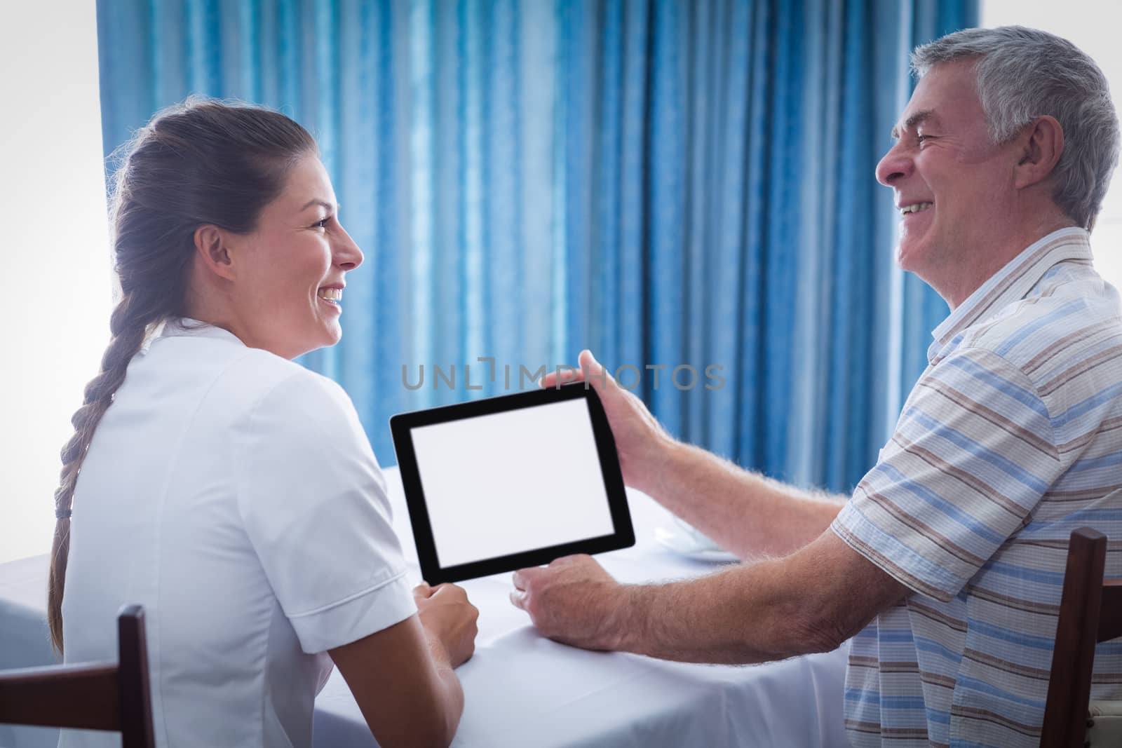 Senior man and female doctor using digital tablet by Wavebreakmedia