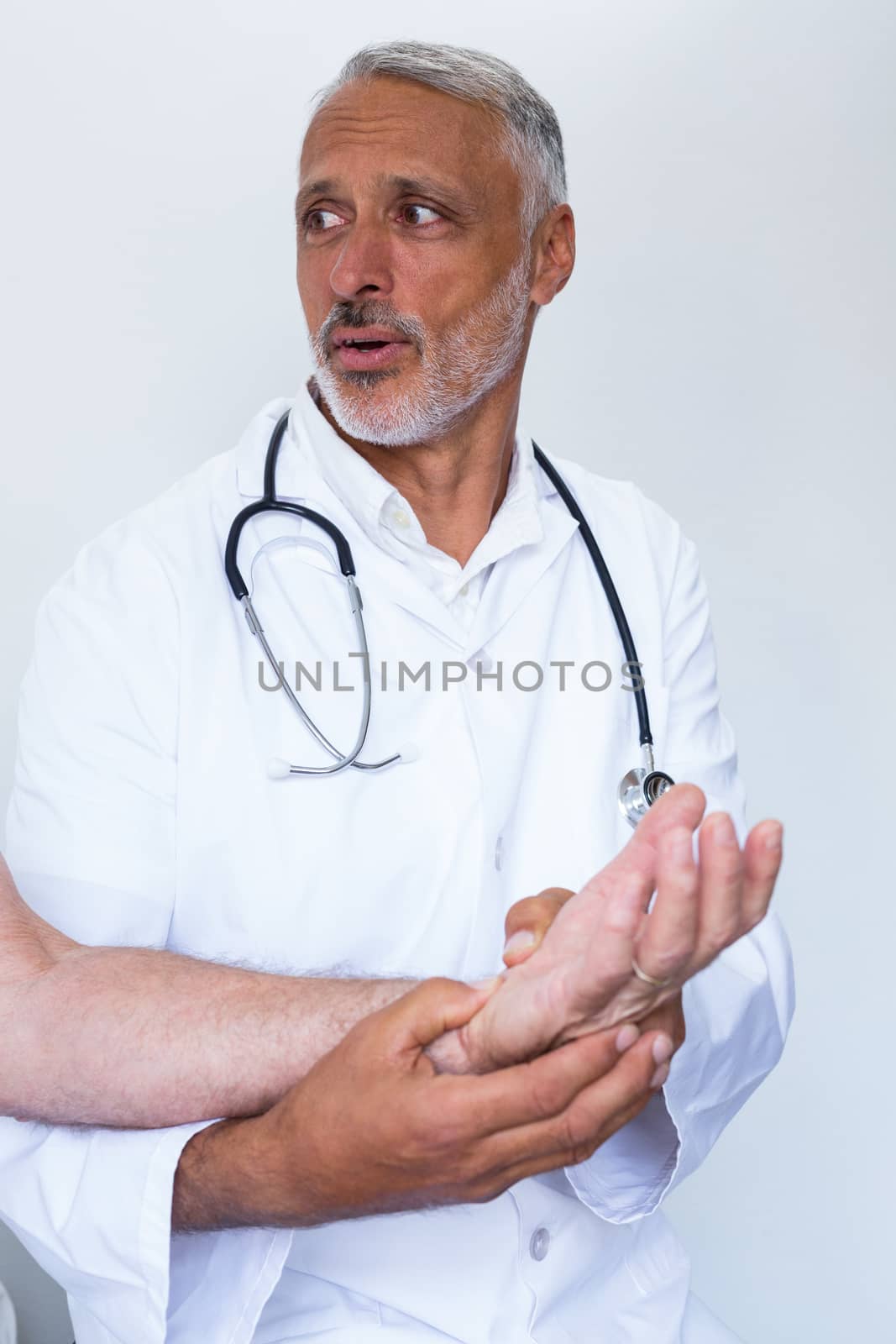 Male doctor giving palm acupressure treatment to the patient by Wavebreakmedia