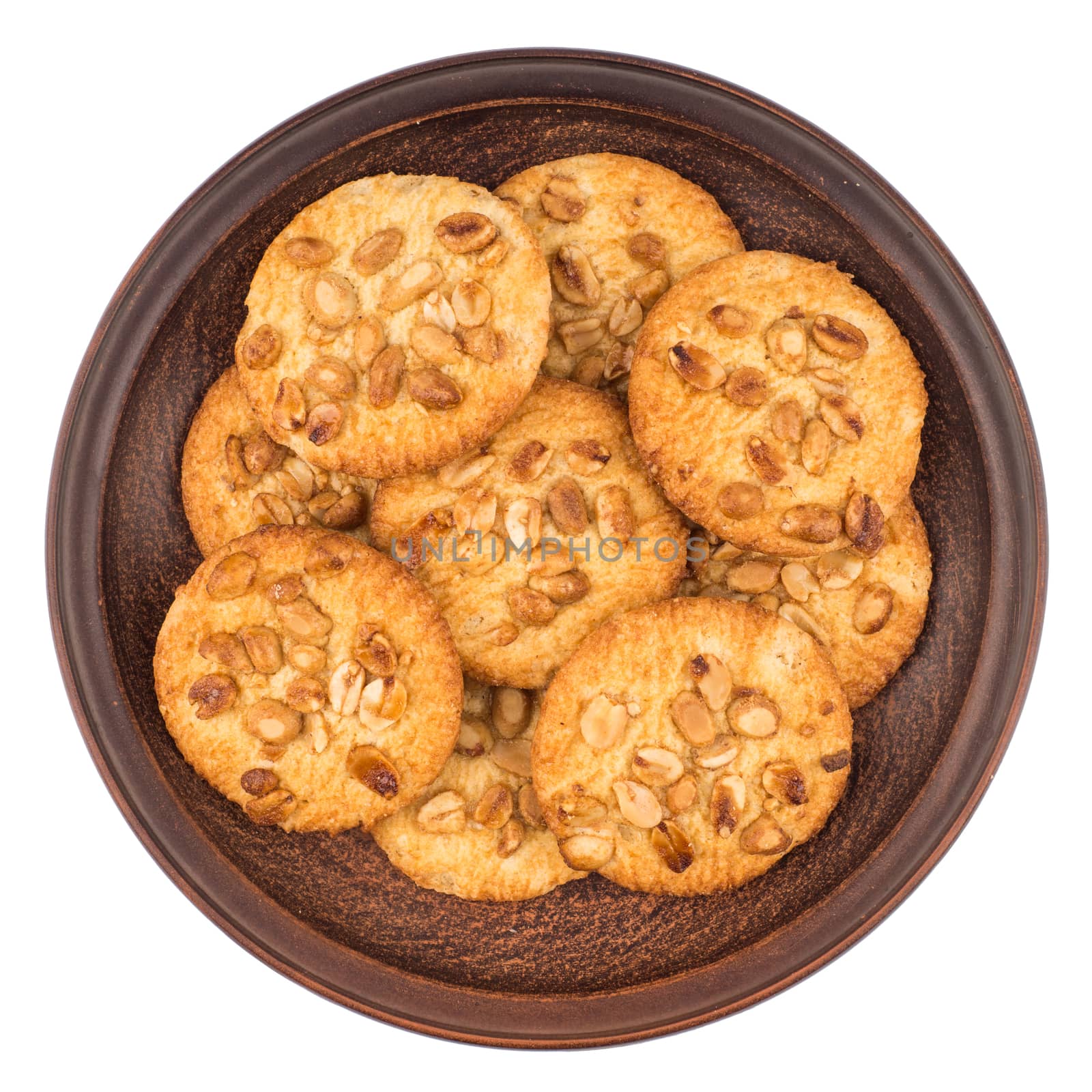 Peanut cookies in a brown plate. Isolated on white background. Top view.