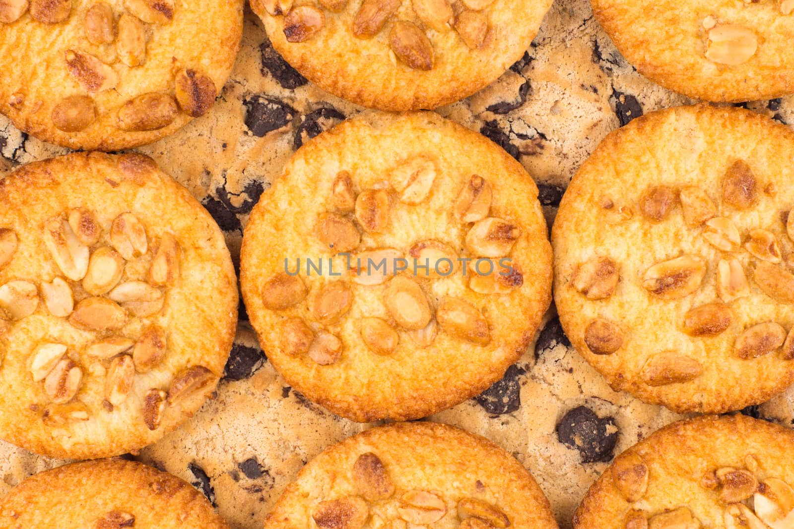 Cookies with peanuts and chocolate. Background texture close-up.