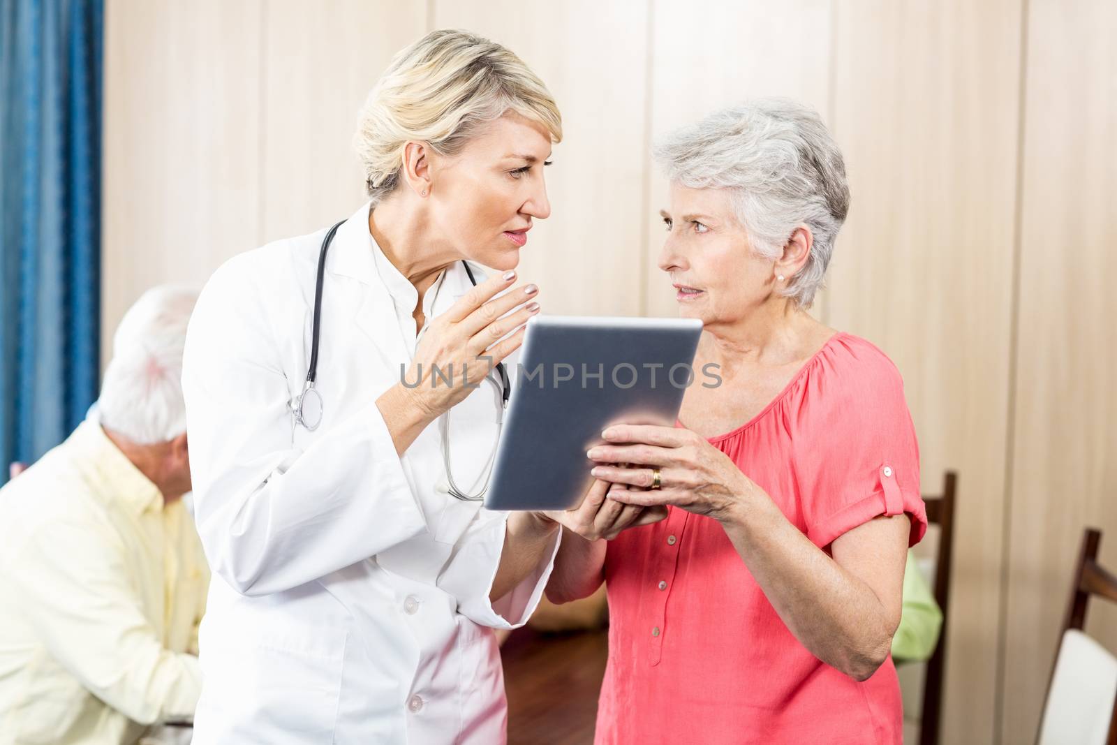 Nurse talking to a senior woman in a retirement home