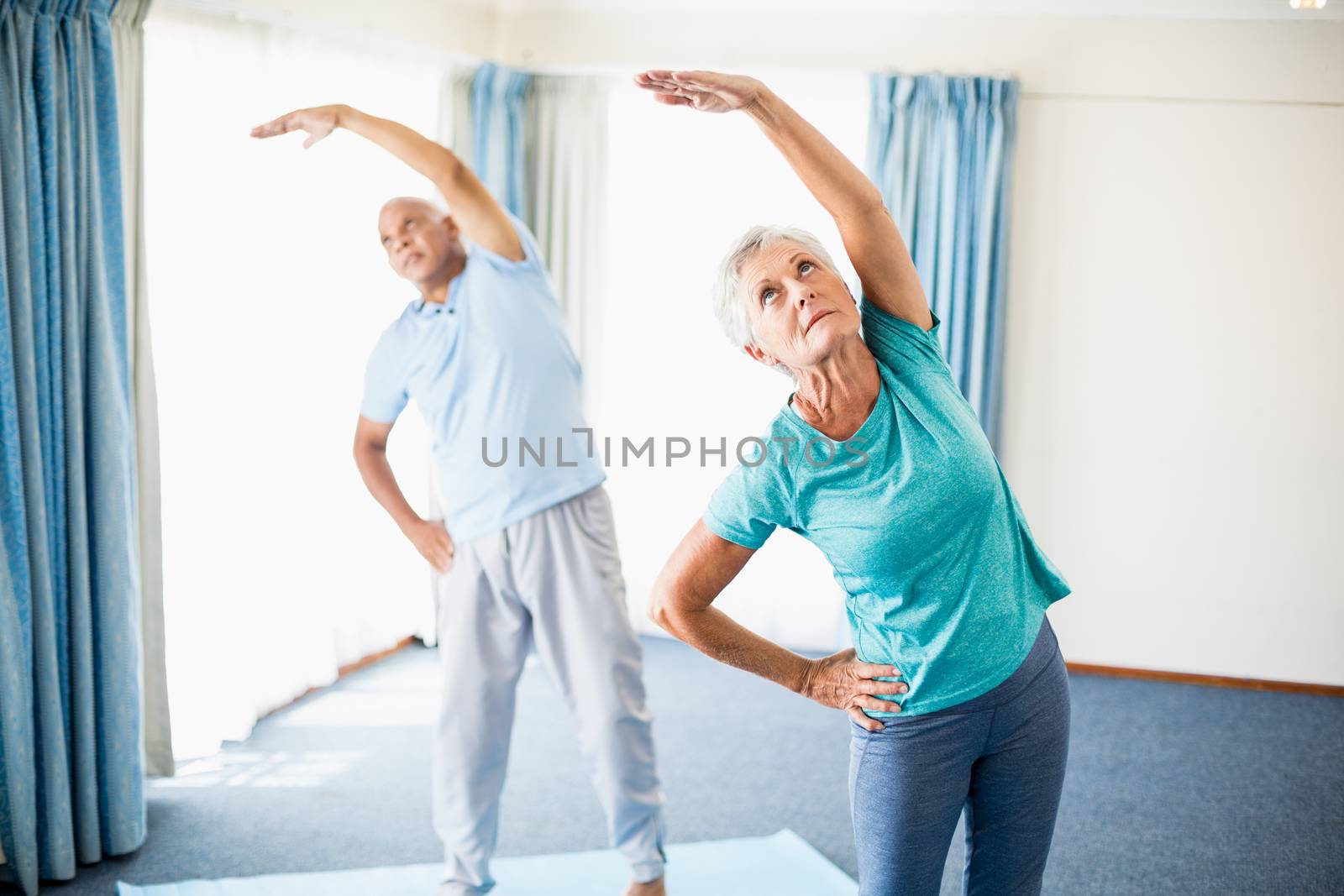Seniors doing stretching in a studio