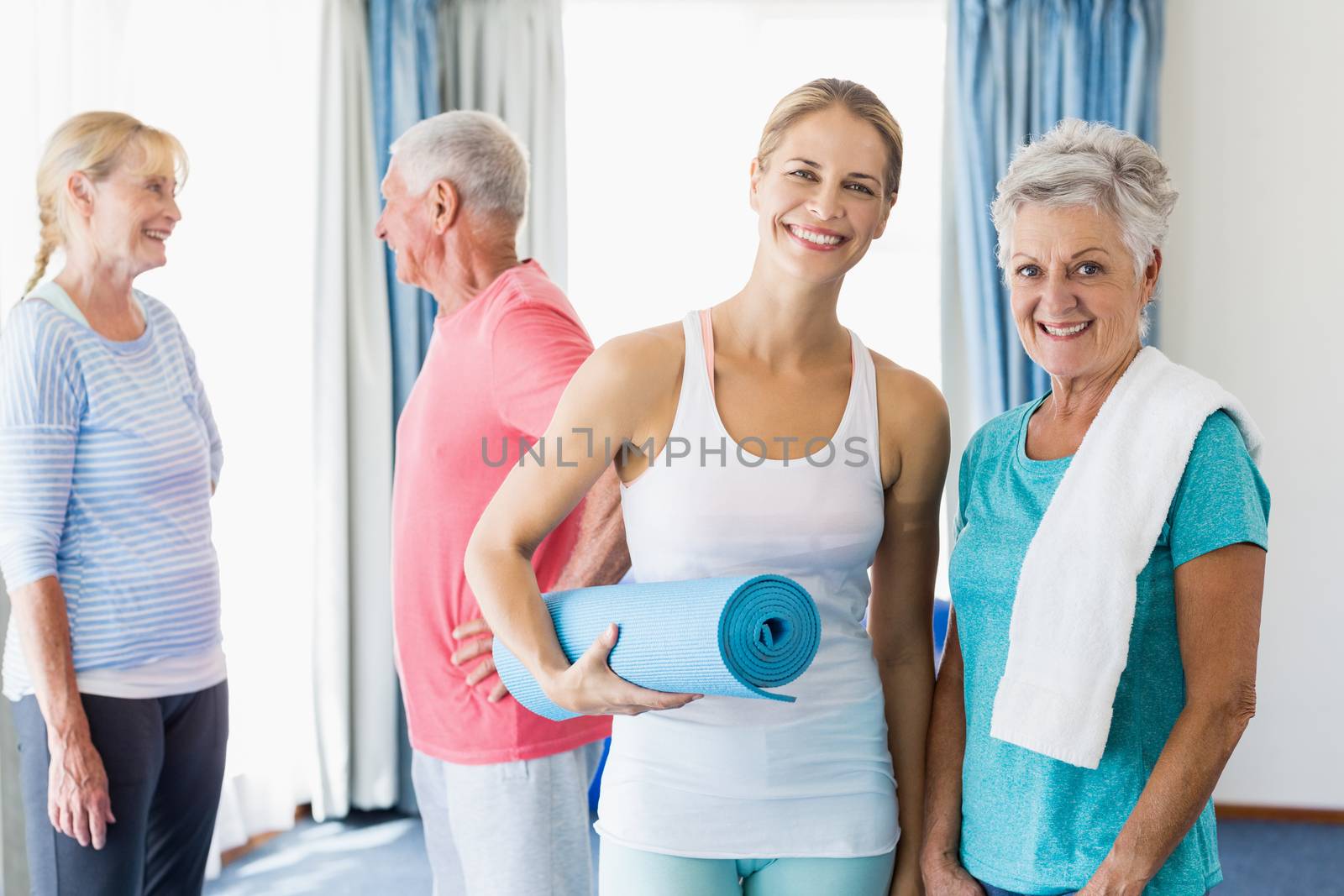 Instructor standing together with seniors during sports class