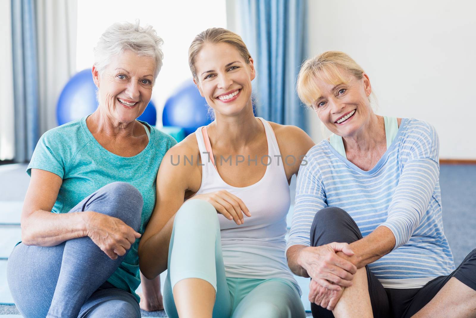 Instructor and senior women sitting in a studio