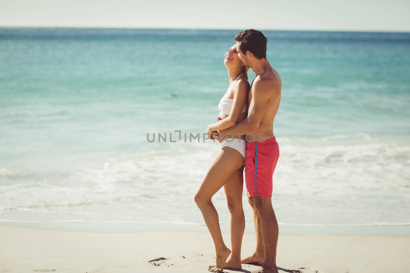 Romantic young couple having fun on beach