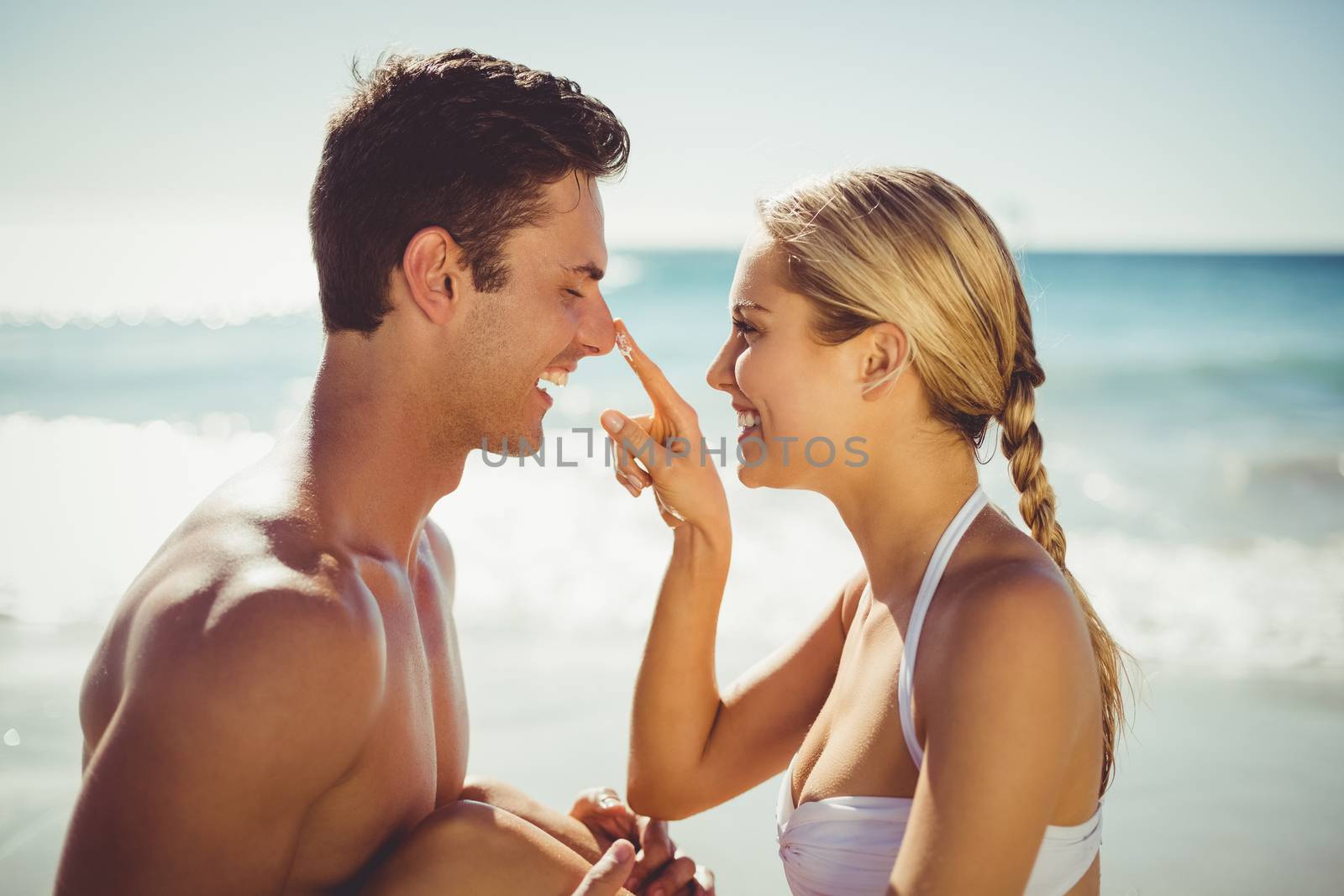 Couple having fun on beach by Wavebreakmedia