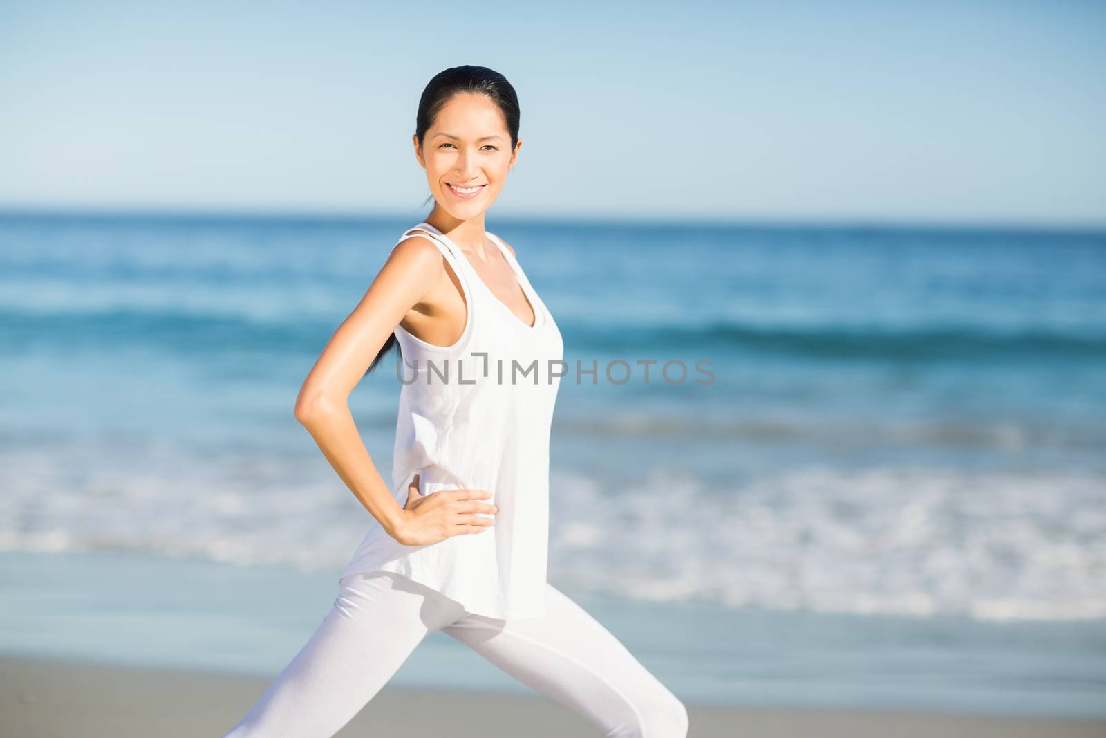 Portrait of young woman doing yoga on the beach