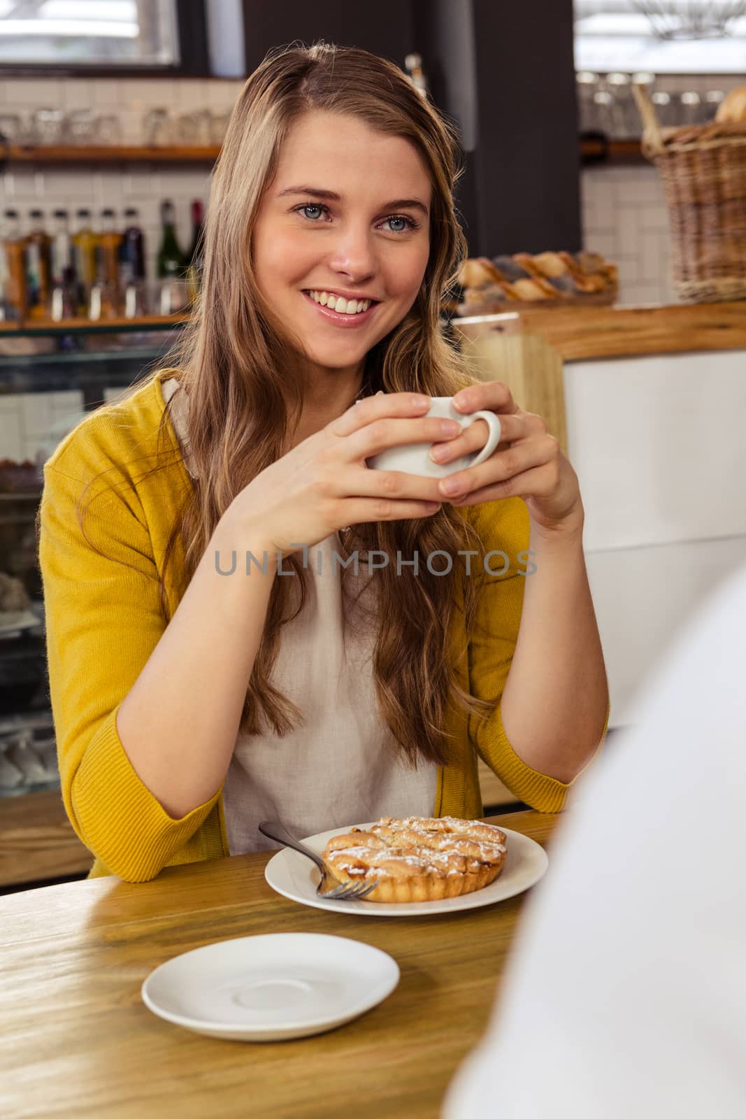 Smiling casual woman drinking a coffee in the restaurant
