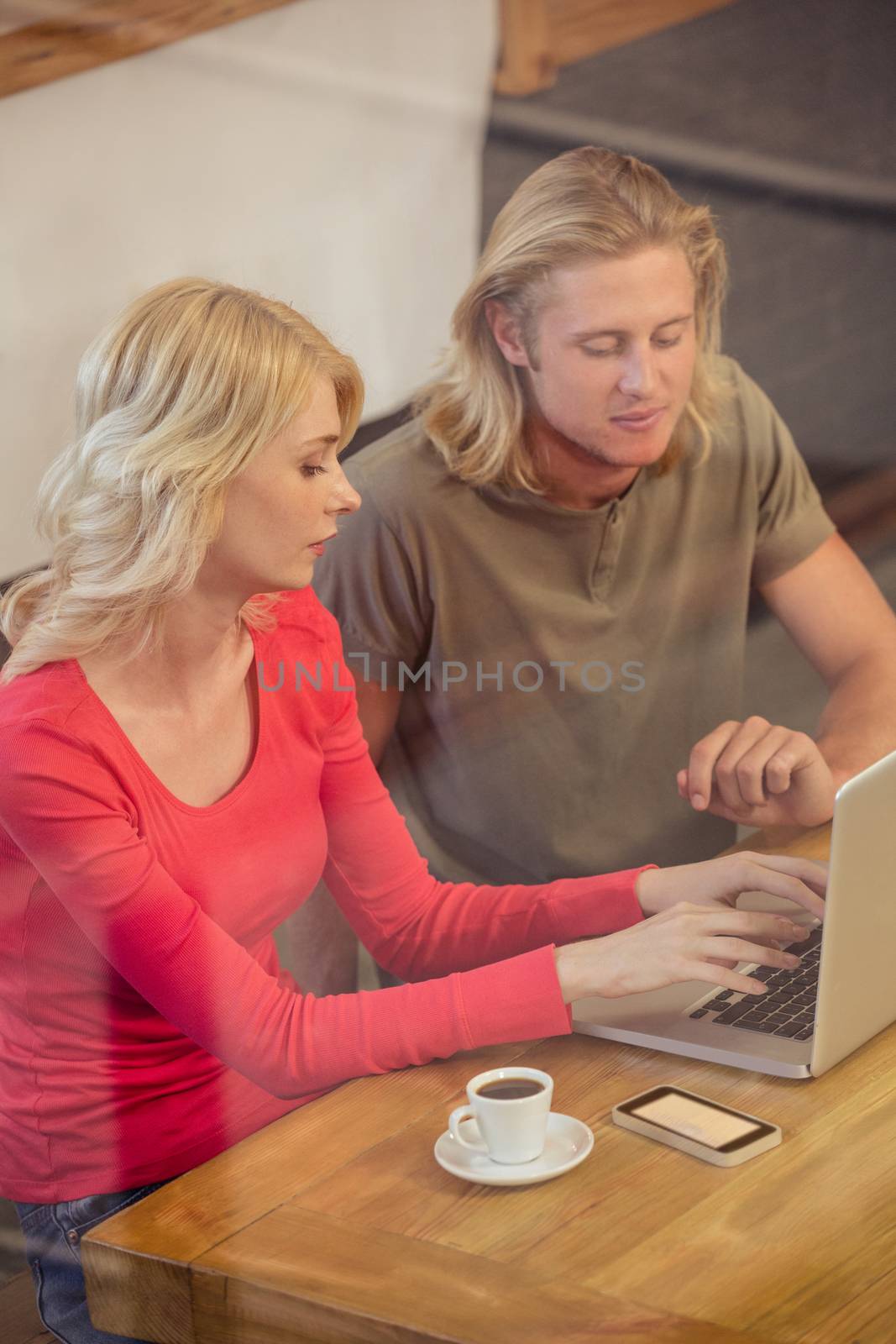 Couple using a laptop in the cafe
