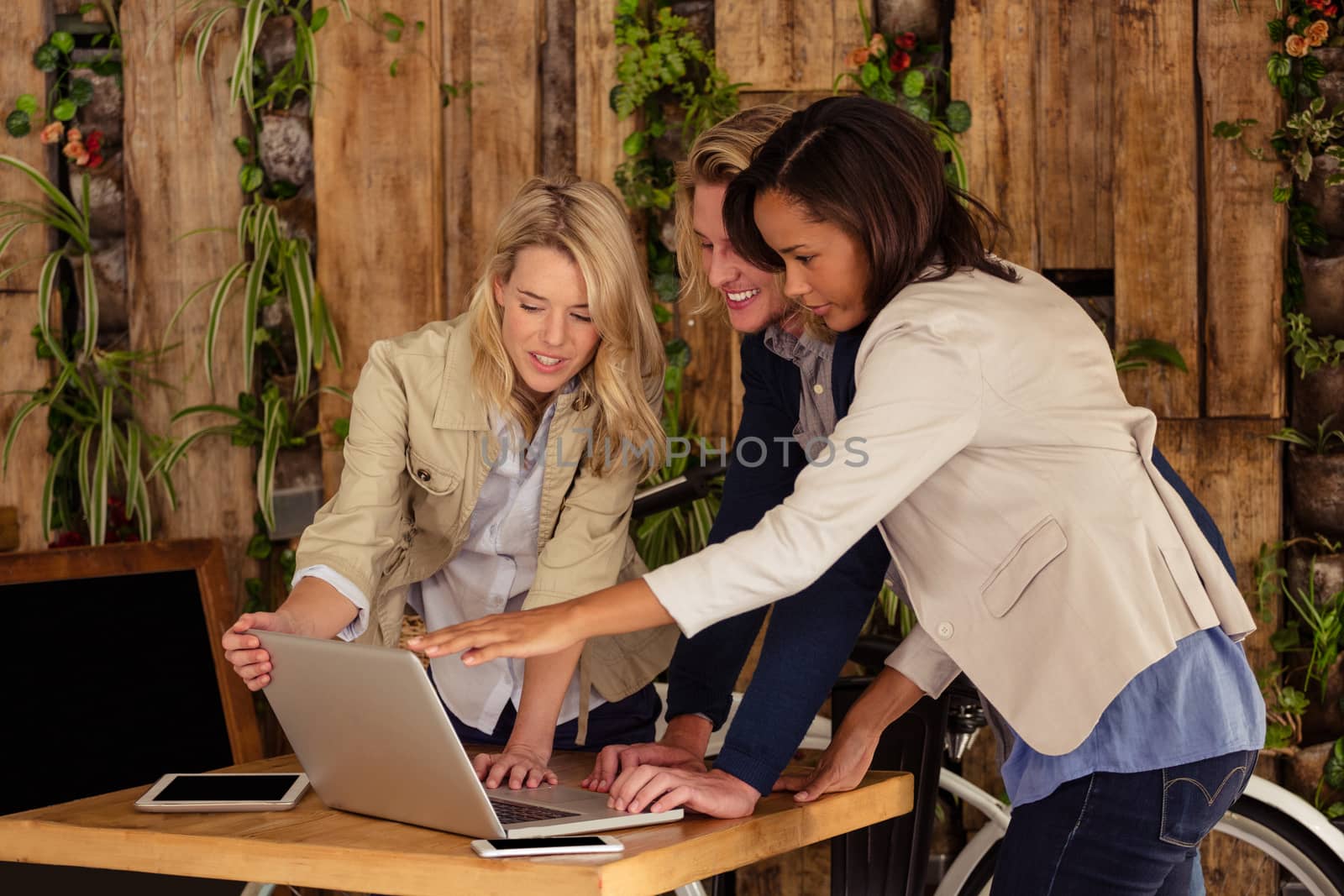 Friends using a laptop in the cafe