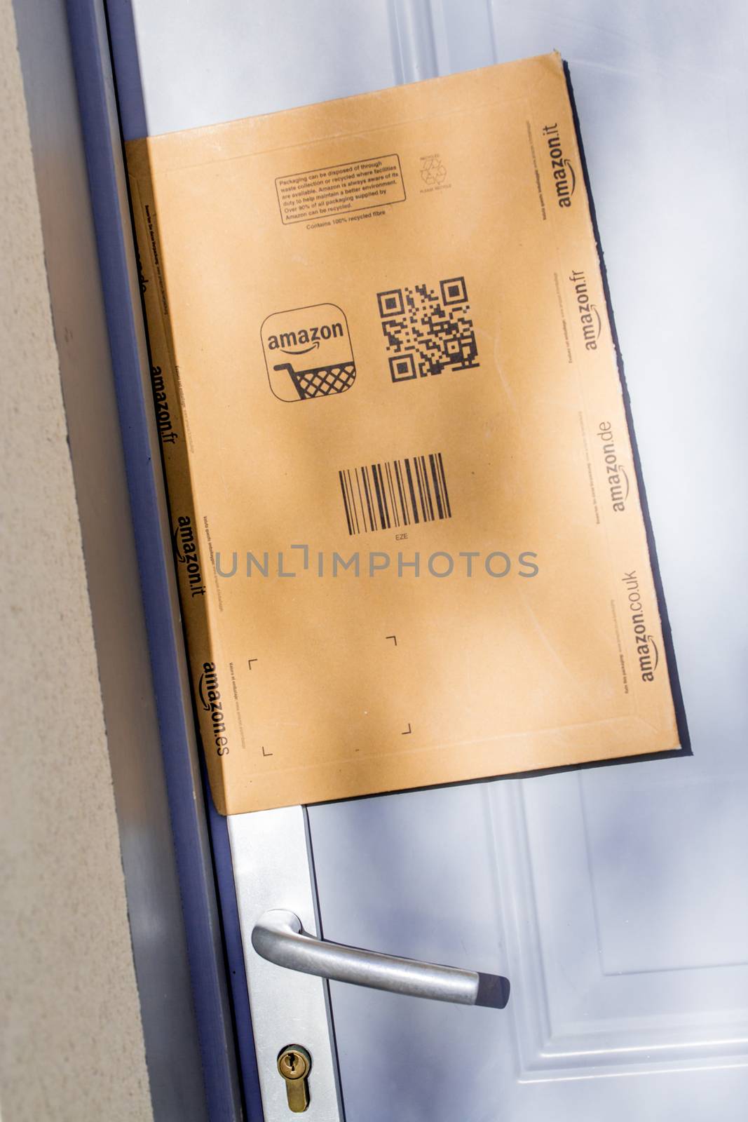 Paris, France - February 08, 2017: Amazon Prime Parcel Package Stuck on the door of a house. Amazon, is an American electronic commerce and cloud computing company,based in Seattle, Started as an online bookstore, Amazon is become the most importrant retailer in the United States