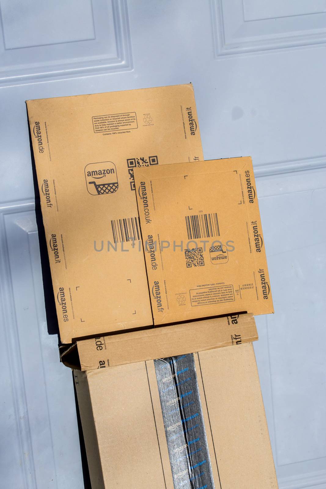 Paris, France - February 08, 2017: Amazon Prime Parcel Package in front the door of a house. Amazon, is an American electronic commerce and cloud computing company,based in Seattle, Started as an online bookstore, Amazon is become the most importrant retailer in the United States