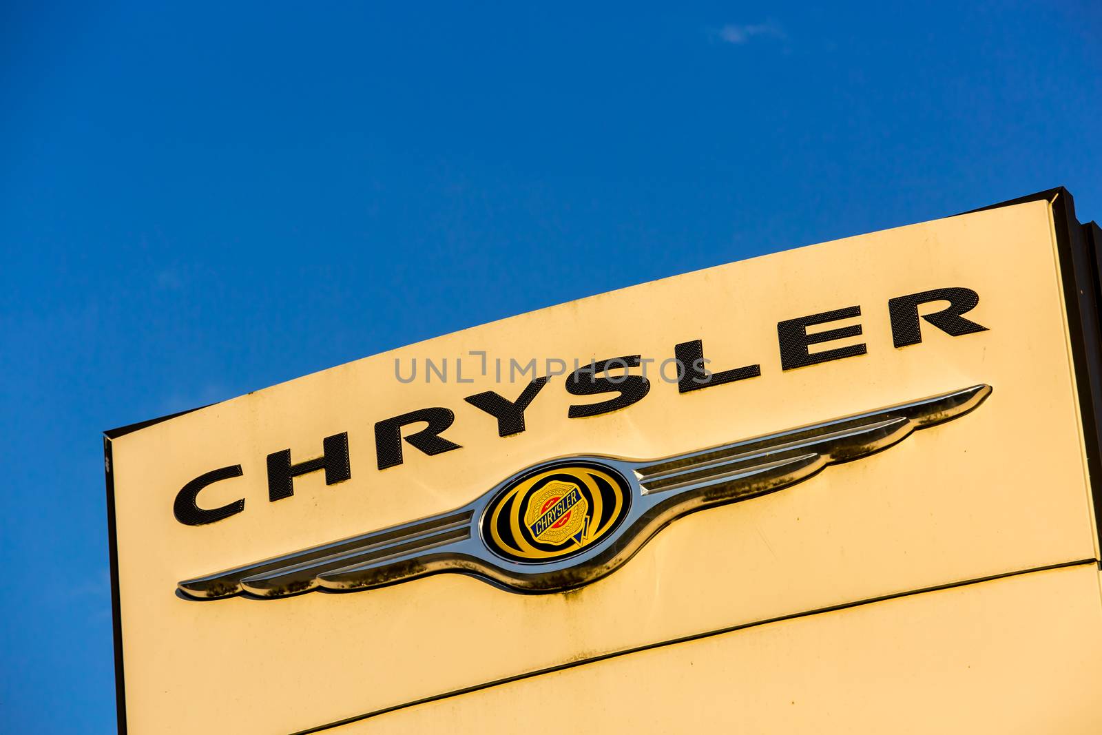 La rochelle, France - August 30, 2016: Official dealership sign of Chrysler against the blue sky. Chrysler is the American subsidiary of Fiat Chrysler Automobiles N.V., an Italian controlled automobile manufacturer registered in the Netherlands with headquarters in London, U.K.
